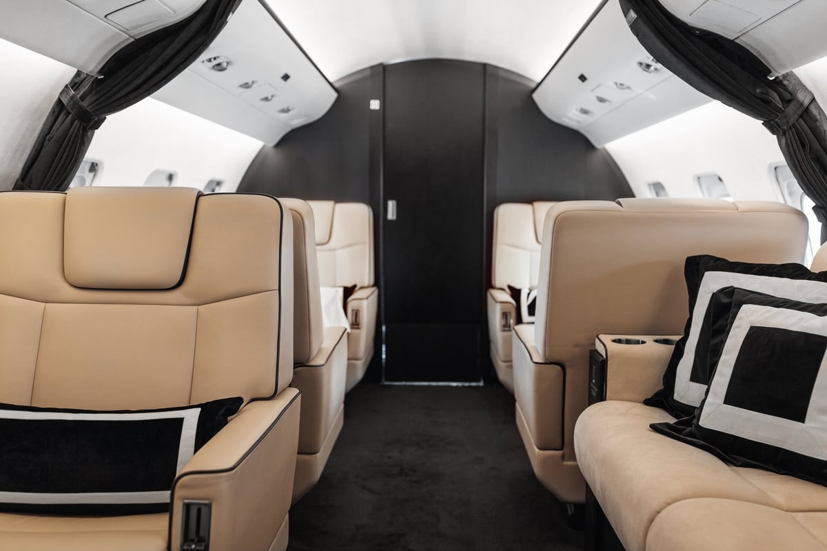 The interior of a private business jet with comfortable leather seats