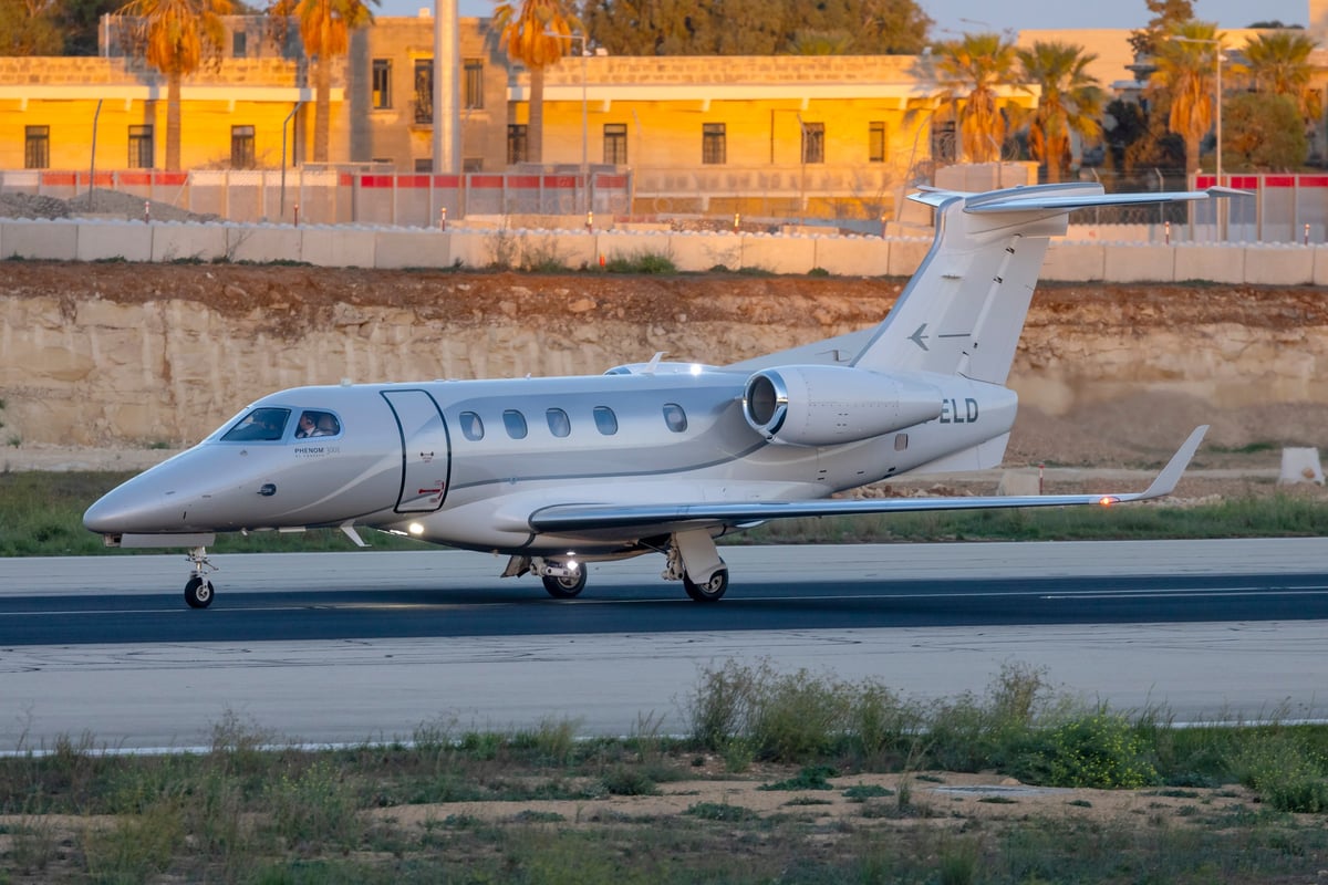 A light private jet climbing into a clear sky