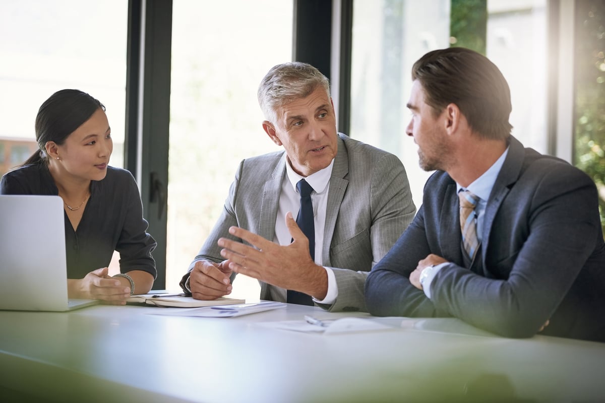 A team of businesspeople meeting around a boardroom table